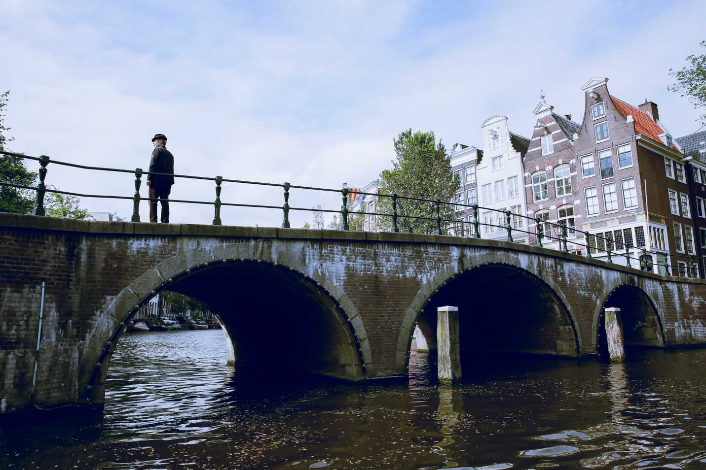Boy standing on a bridge in the canals